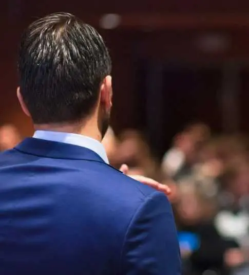 A man in a blue suit is standing up