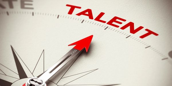 A pair of scissors on top of paper with the word " talent " written in red.