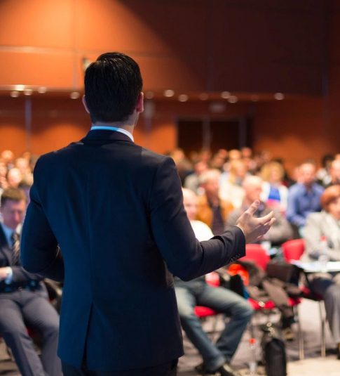 A man in a suit is giving a presentation.