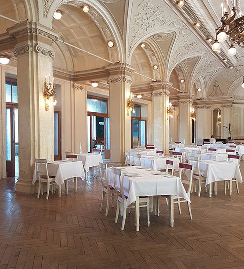 A large room with many tables and chairs.